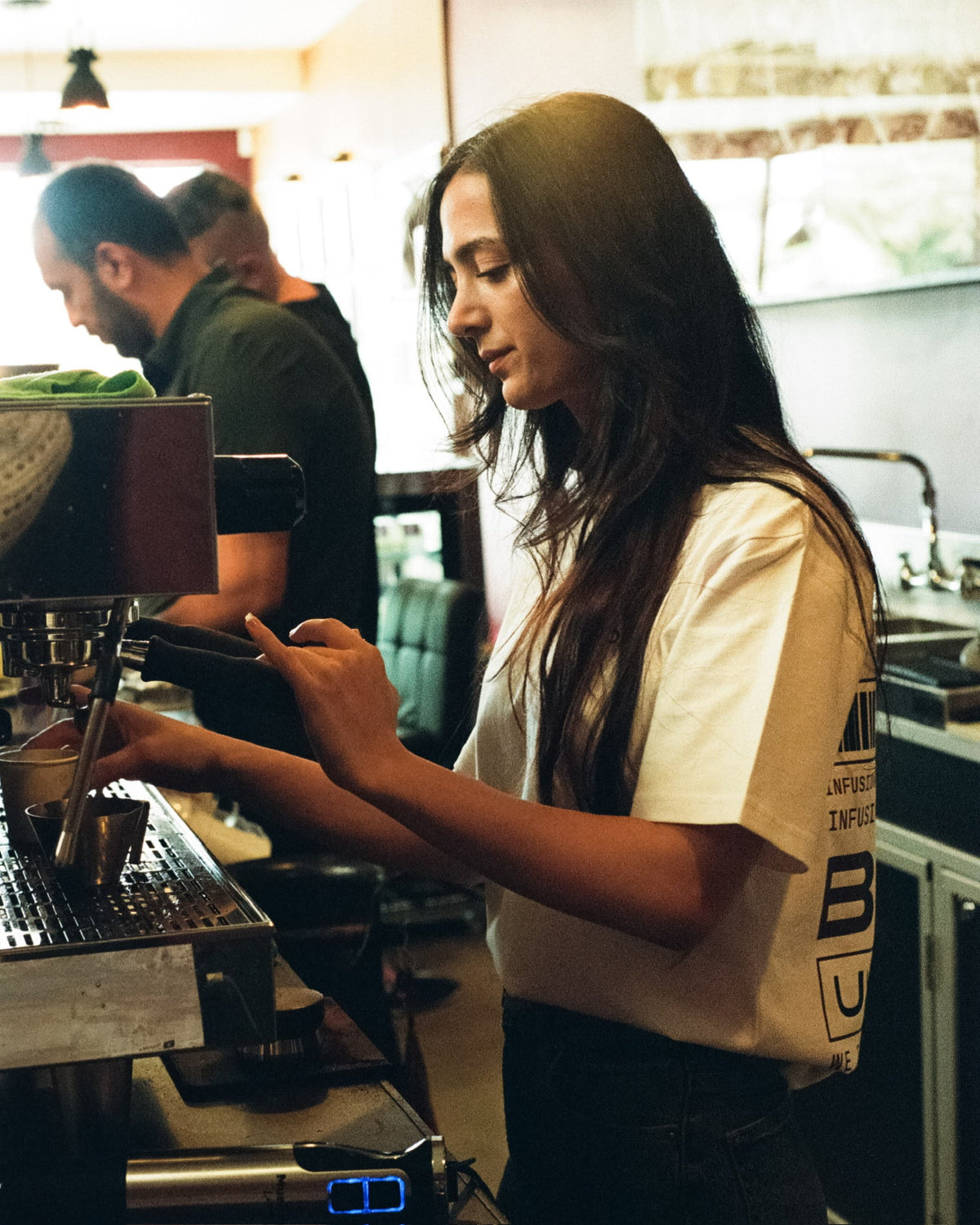 A barista preparing a drink at Infusion Lab’s espresso machine.