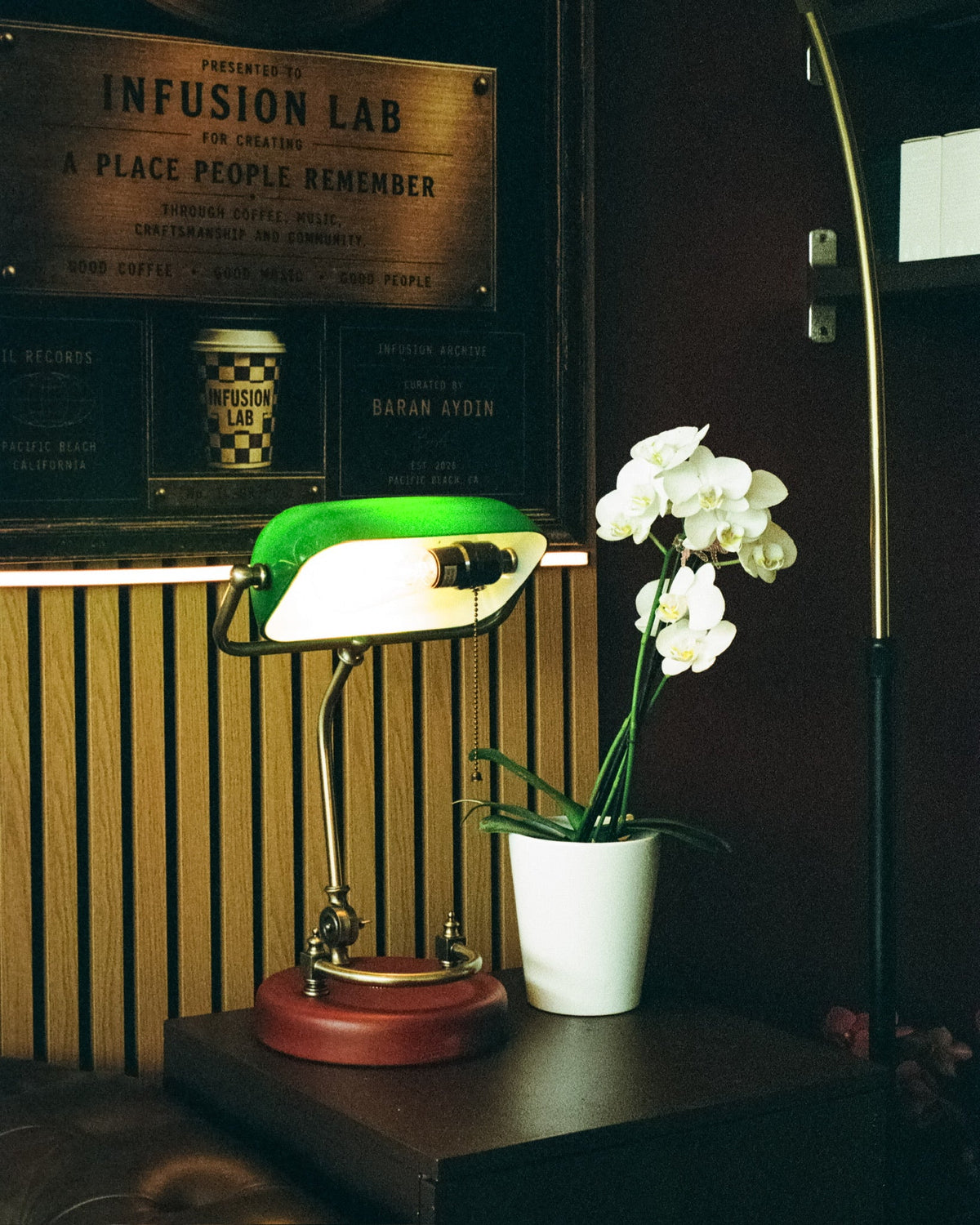 Green banker lamp, white orchid and brass Infusion Lab plaque
