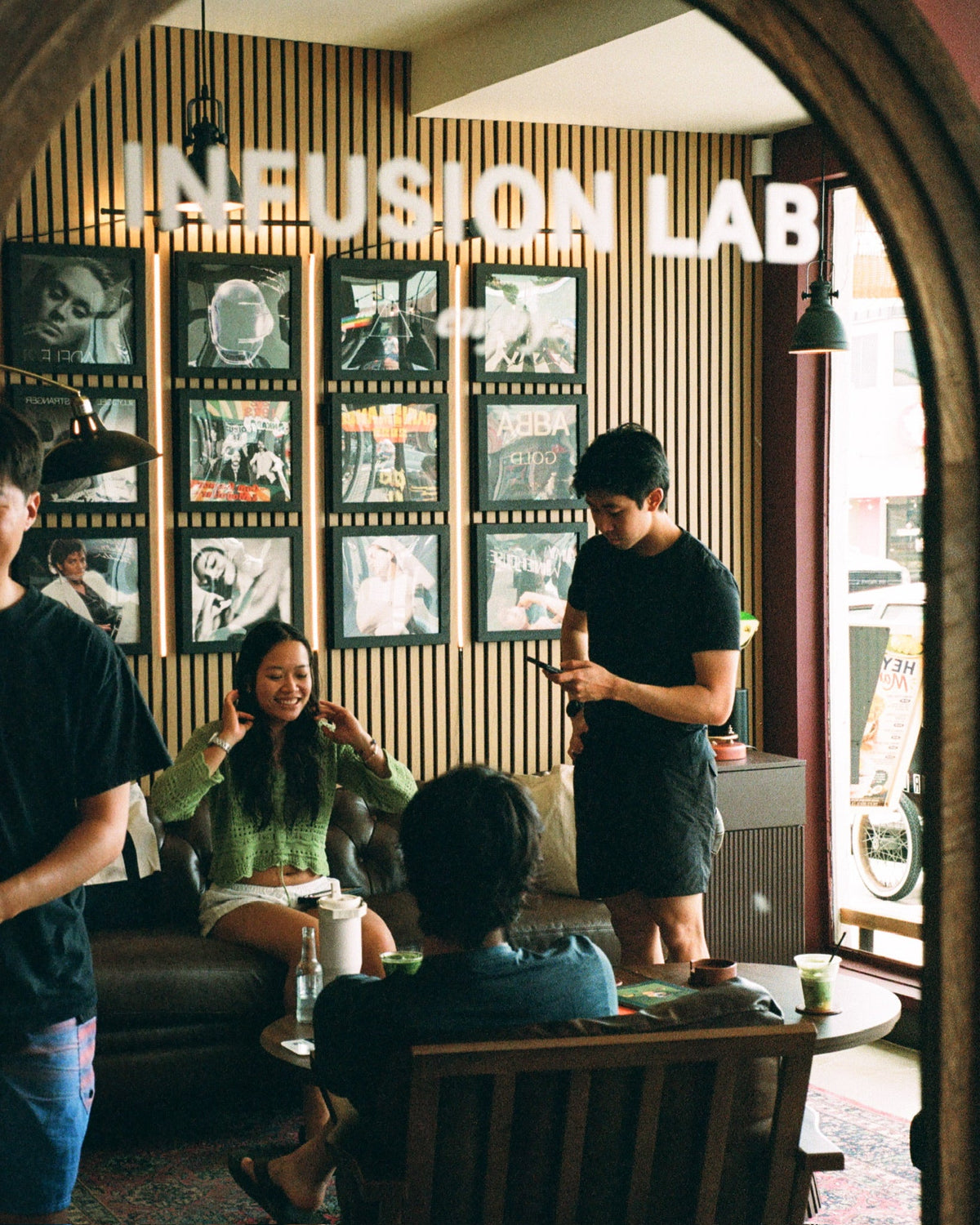 Guests in the Infusion Lab lounge with framed records on the wall